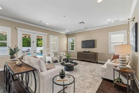 a dining room with furniture a potted plant and a chandelier