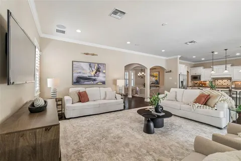 a view of a dining room with furniture wooden floor and chandelier