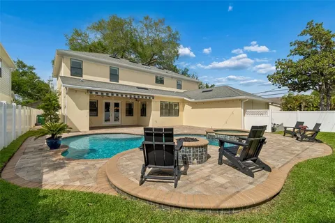 a view of a house with backyard sitting area and garden