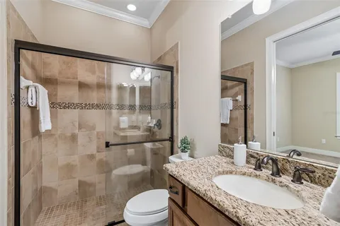 a bathroom with a granite countertop sink mirror and double
