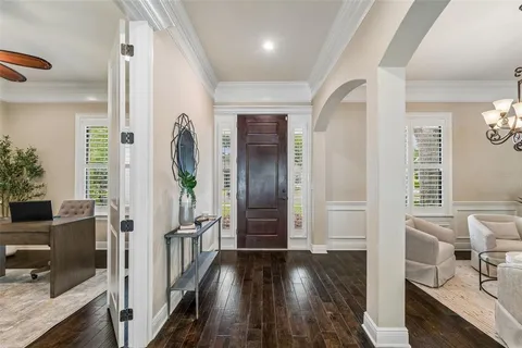 a kitchen with white cabinets and sink