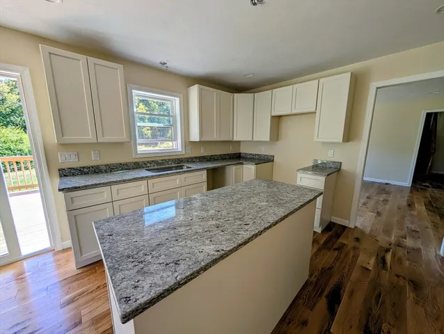 a kitchen with a sink a refrigerator and wooden cabinets
