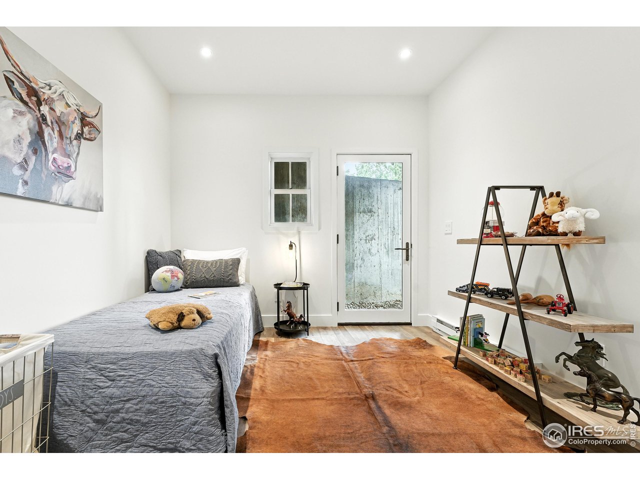 360 Boulder Street Boulder, CO 80302 - Photo 21 of 37 a bedroom with a bed and wooden floor