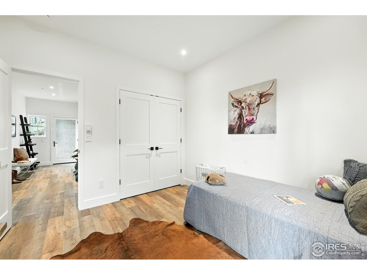 360 Boulder Street Boulder, CO 80302 - Photo 22 of 37 a bedroom with a bed and wooden floor
