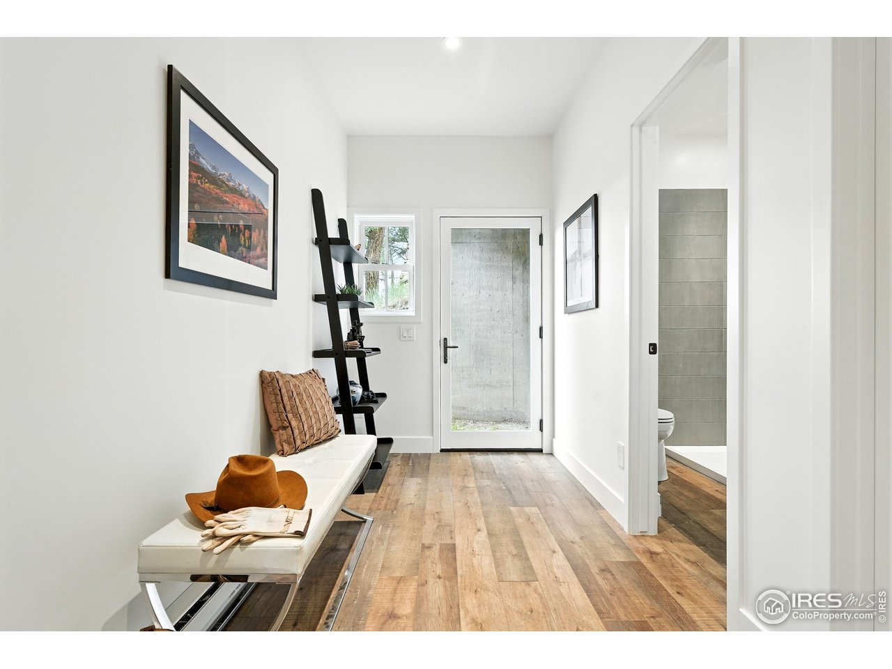 360 Boulder Street Boulder, CO 80302 - Photo 6 of 37 a bedroom with a bed and a painting on the wall