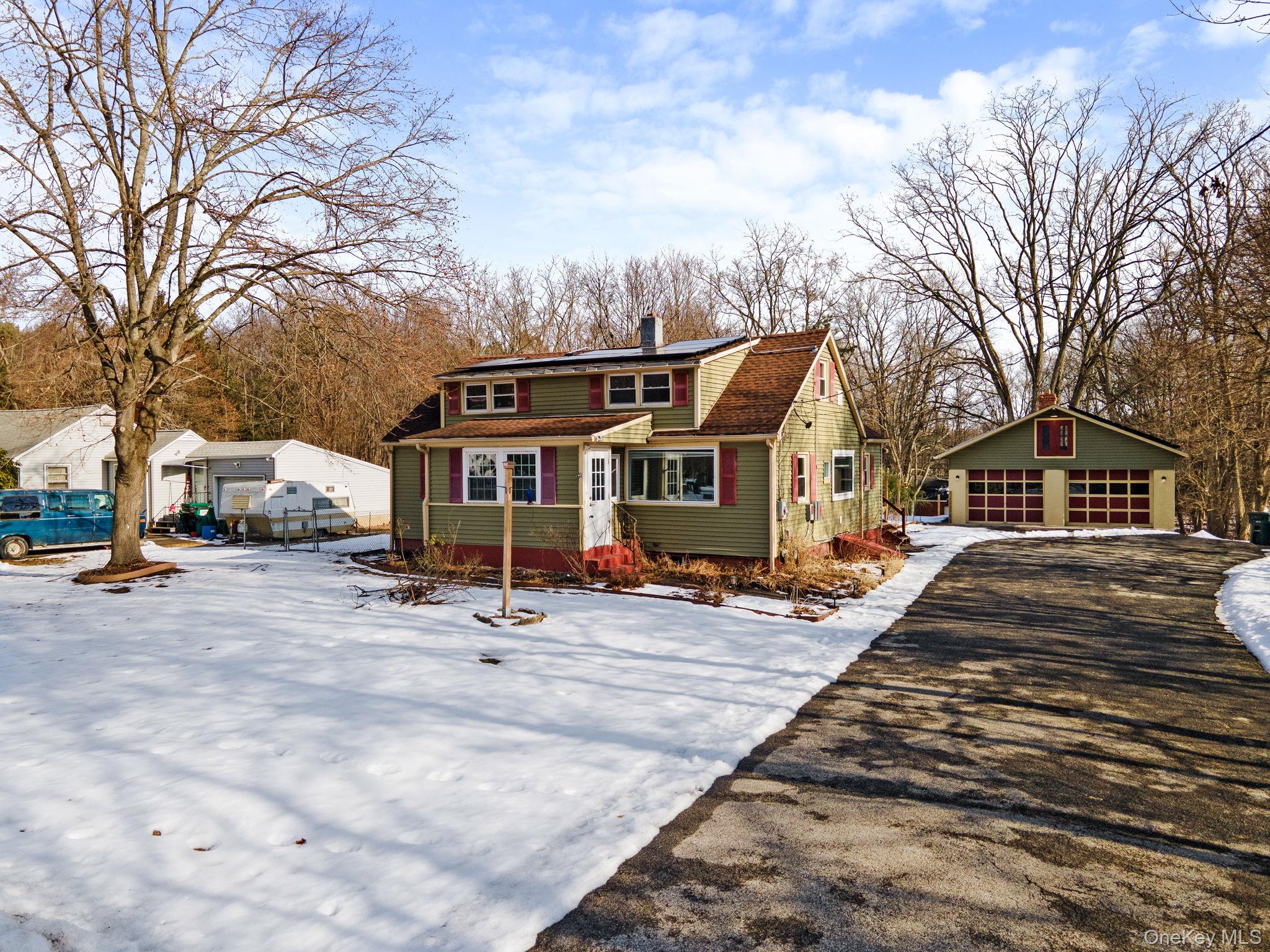 a front view of house with yard outdoor seating and barbeque oven