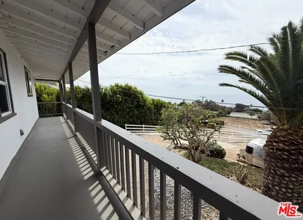 a view of a balcony with an ocean view