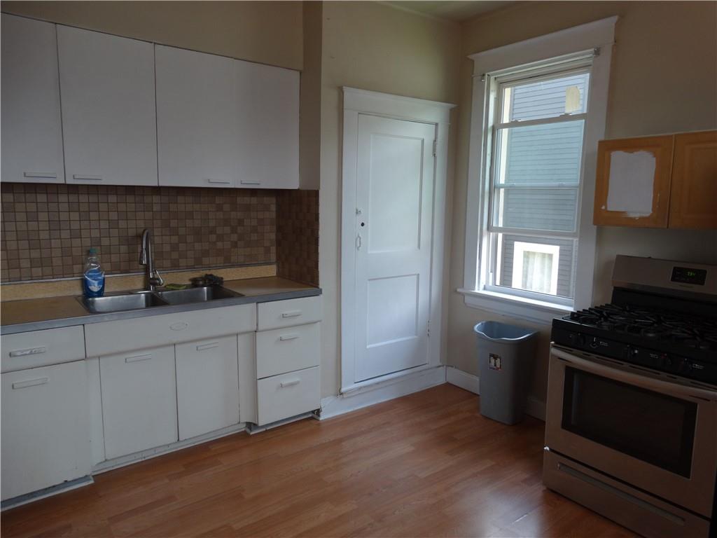 511 Chestnut Street Carnegie, PA 15106 - Photo 13 of 24 a kitchen with stainless steel appliances a stove a sink and a microwave