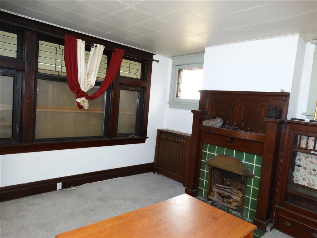 511 Chestnut Street Carnegie, PA 15106 - Photo 4 of 24 a living room with a fireplace furniture a rug and a window