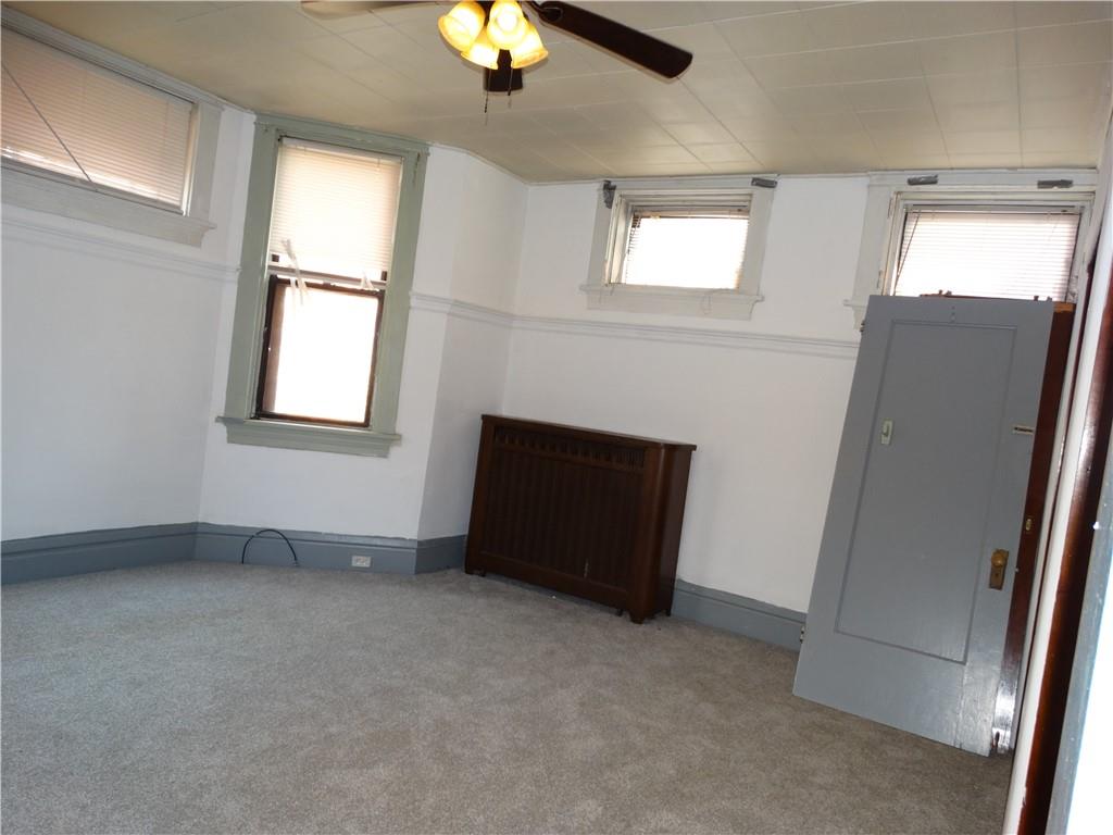 511 Chestnut Street Carnegie, PA 15106 - Photo 5 of 24 an empty room with windows and fan