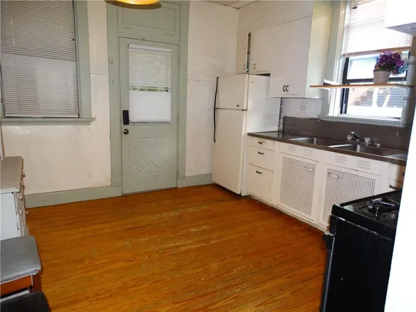 a kitchen with stainless steel appliances a stove refrigerator sink and cabinets