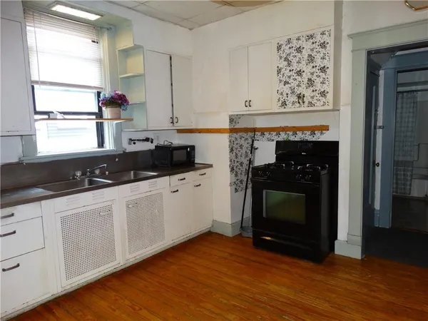 a kitchen with stainless steel appliances a stove top oven and cabinets