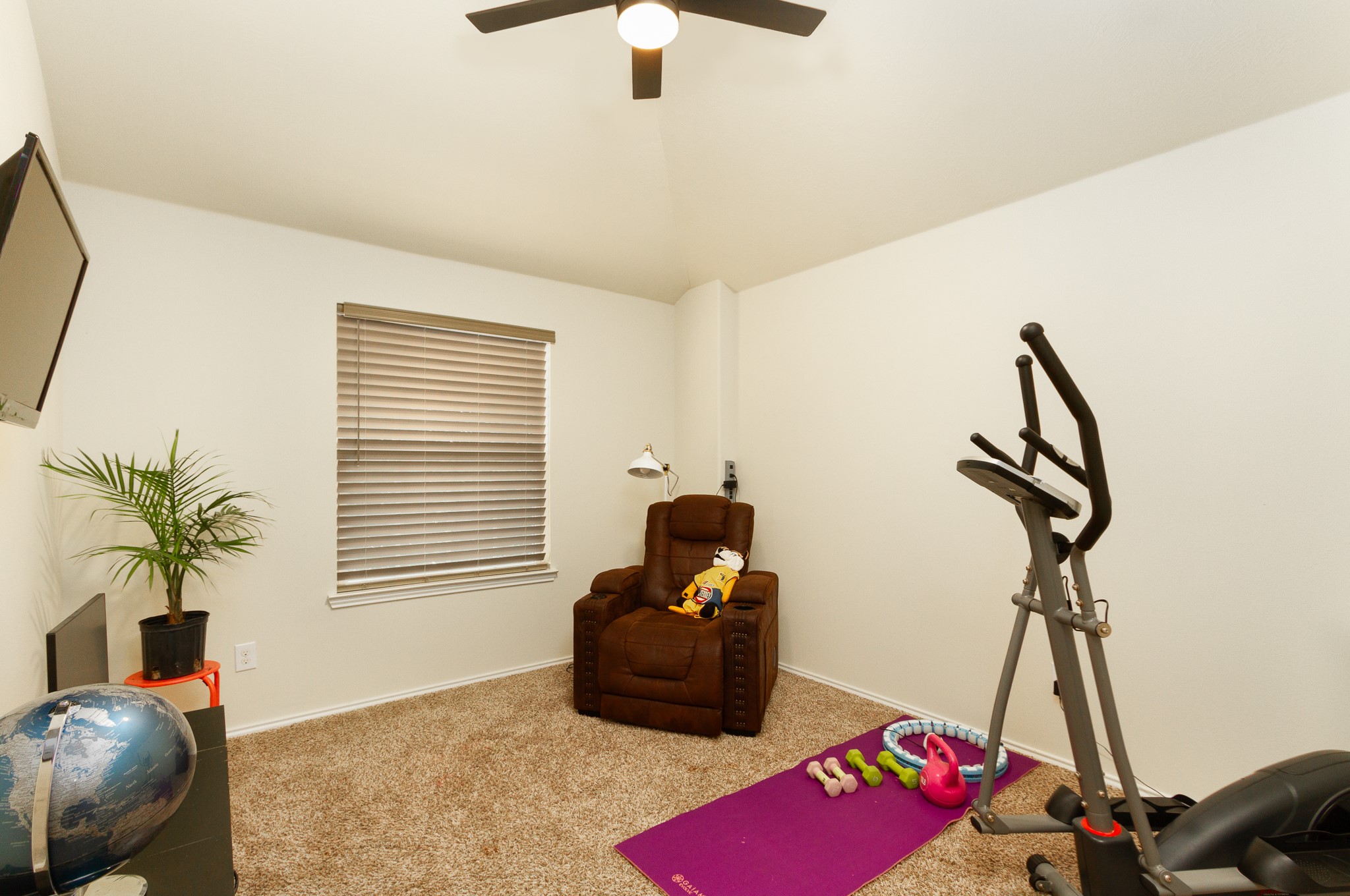 1107 Arum Road Missouri City, TX 77489 - Photo 18 of 23 Bedroom 4 features a high ceiling, ceiling fan, nice closet space and front yard views. This room is currently being used as a gym.