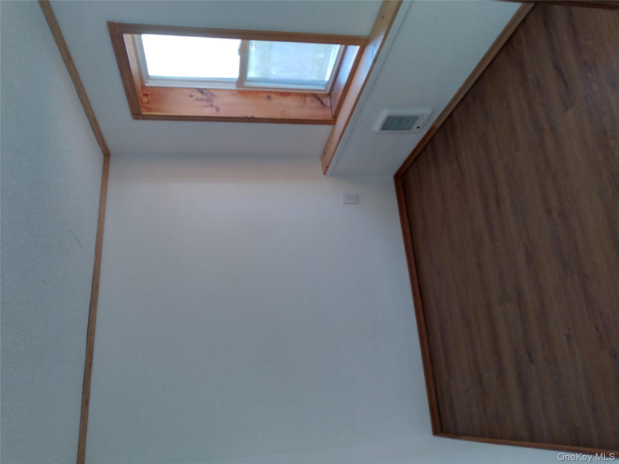 31 Willowemoc Road Livingston Manor, NY 12758 - Photo 17 of 23 a view of an empty room with wooden floor and a window