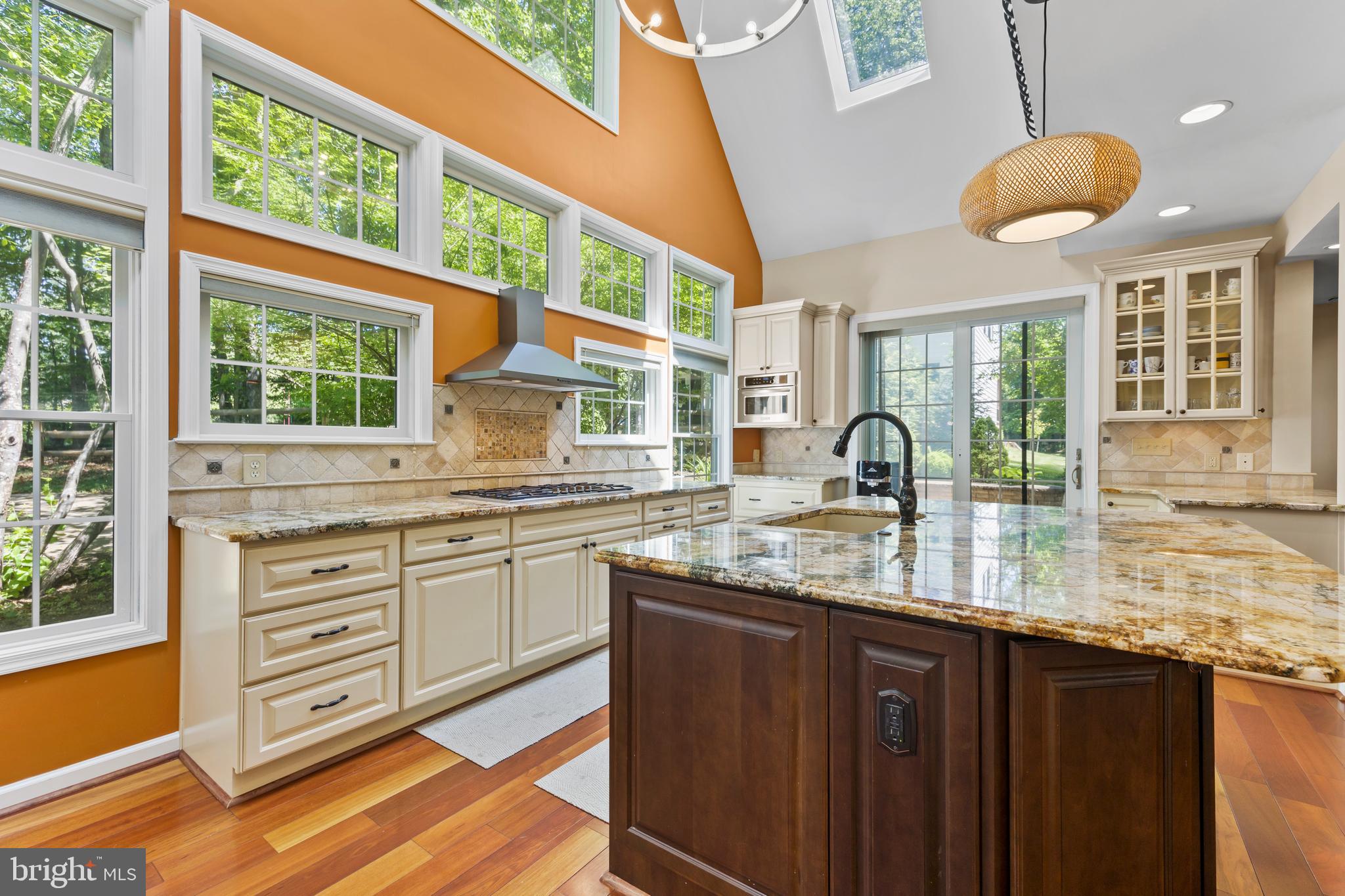 11019 Ring Road Reston, VA 20190 - Photo 23 of 78 a kitchen with granite countertop a stove a sink and wooden floors