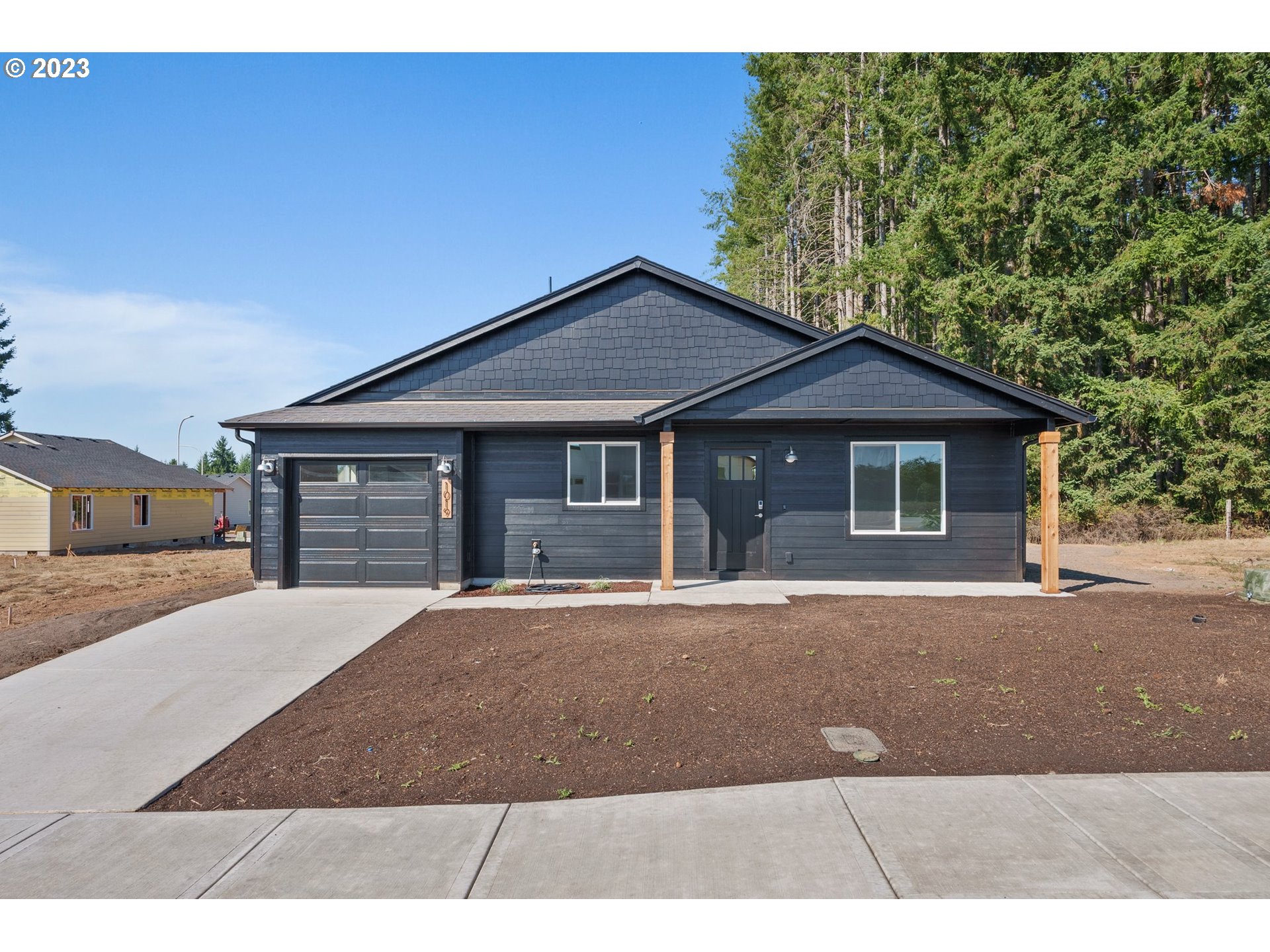 1019 Peach Road Winlock, WA 98596 - Photo 1 of 22 a front view of a house with a yard and garage