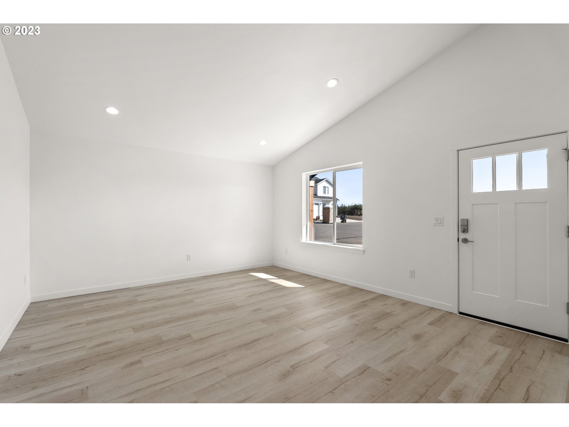 1019 Peach Road Winlock, WA 98596 - Photo 14 of 22 a view of an empty room with wooden floor and a window
