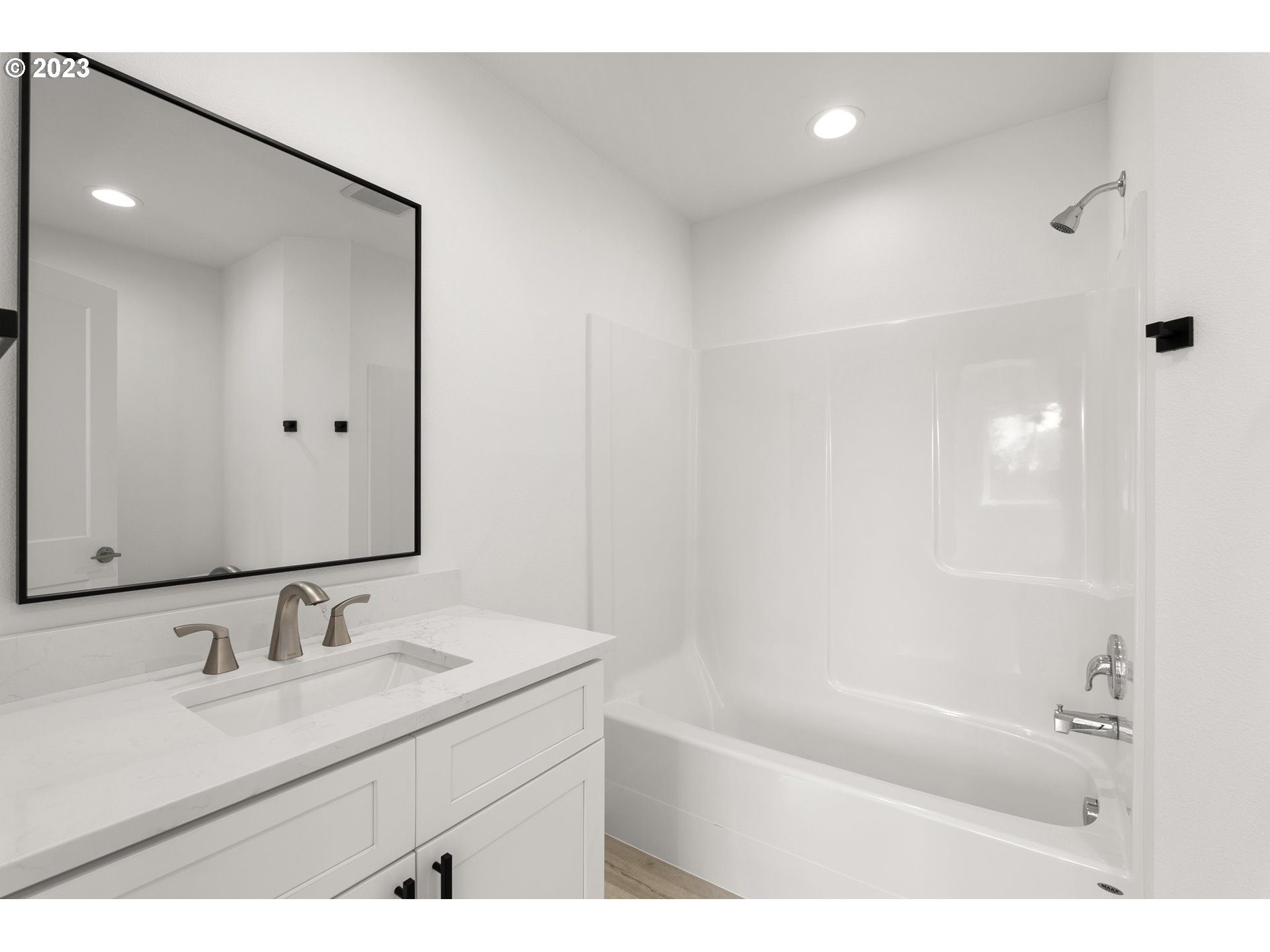 1019 Peach Road Winlock, WA 98596 - Photo 17 of 22 a bathroom with a granite countertop sink mirror and a bathtub