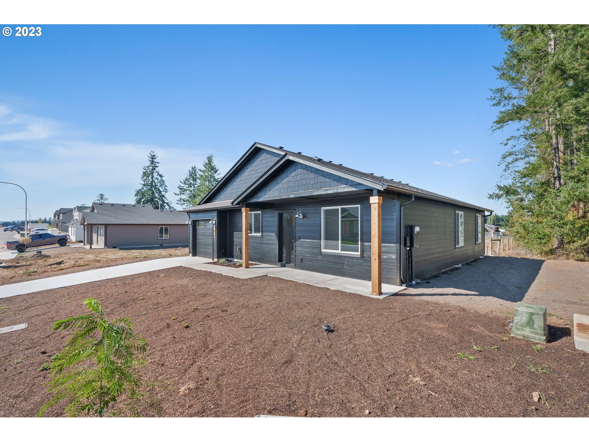 1019 Peach Road Winlock, WA 98596 - Photo 3 of 22 a front view of a house with a yard and garage