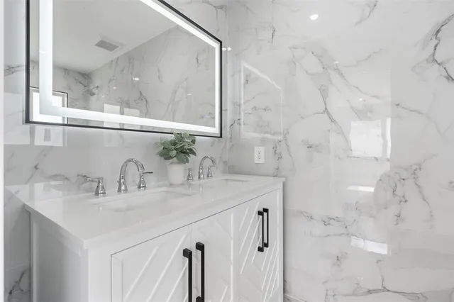 a white toilet sitting next to a shower