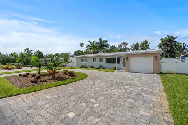a view of a house with a swimming pool and a yard