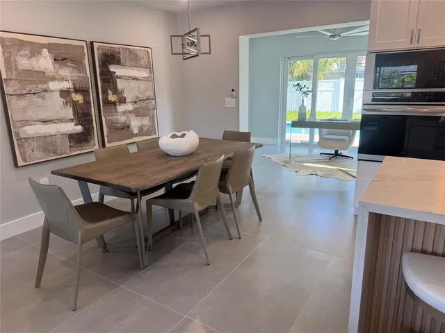 a view of a room with a table and chairs