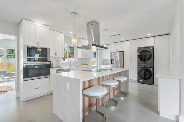 a kitchen with stainless steel appliances a sink stove and refrigerator