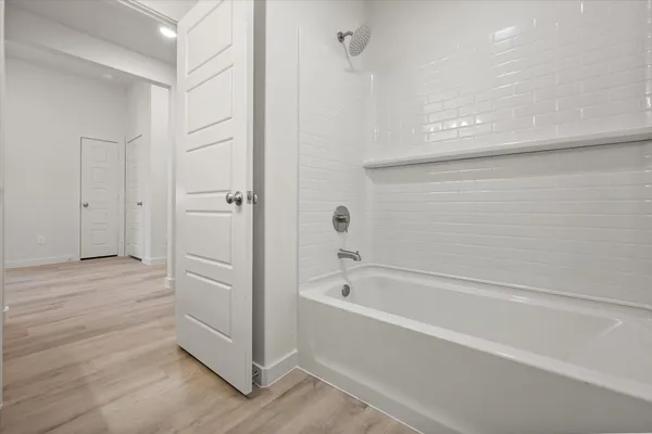 a bathroom with a bathtub and shower