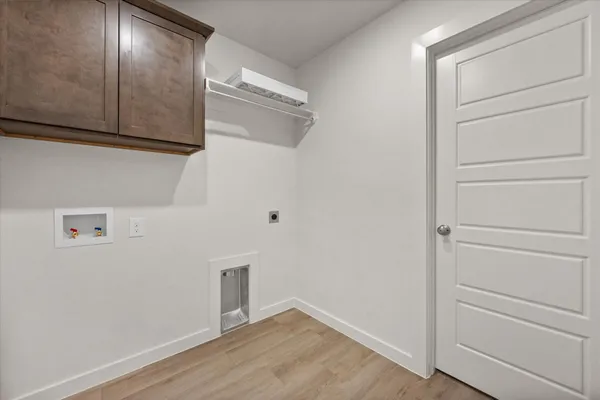 a view of storage and utility room with closet