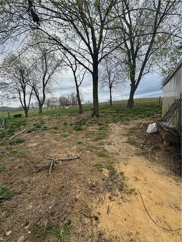 a view of backyard with large trees