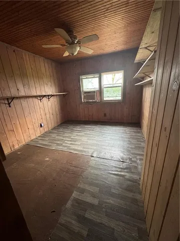 an empty room with windows and mirror