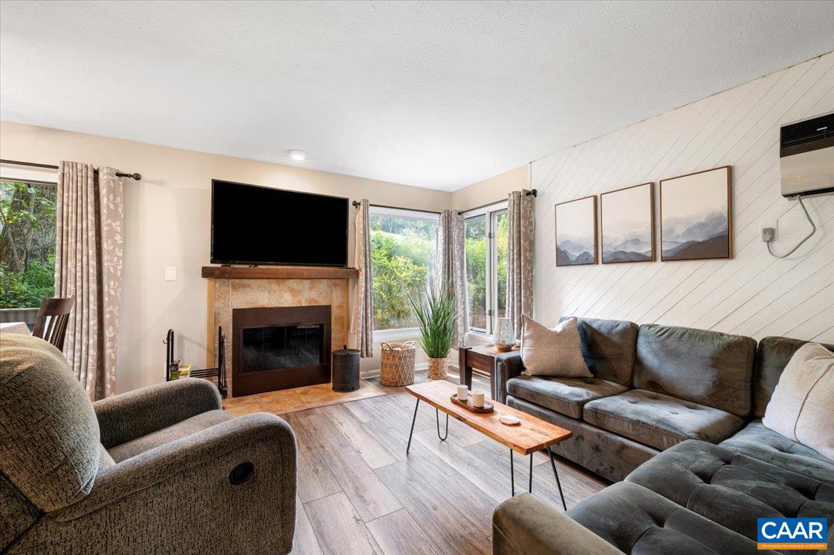 a living room with furniture a flat screen tv and a fireplace