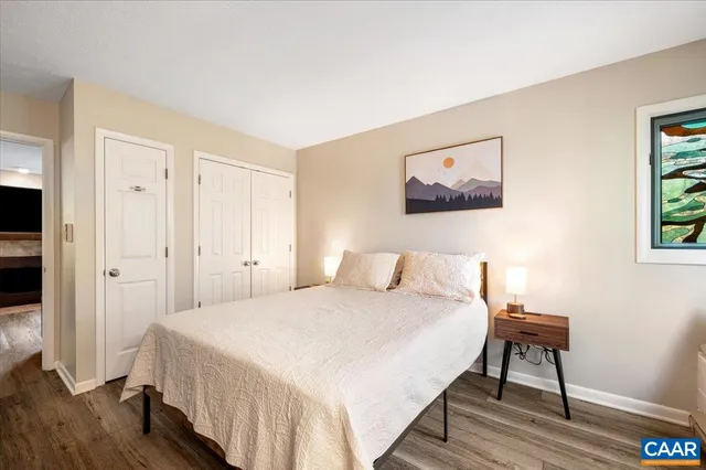 a bedroom with a bed and a painting on the wall