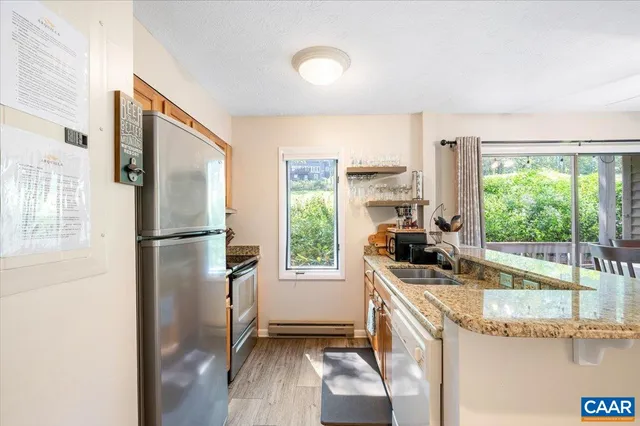 a kitchen with a refrigerator a sink and a large window