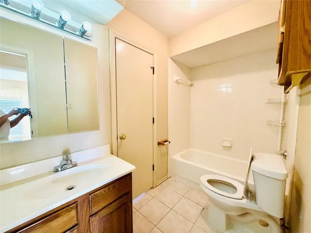 a bathroom with a sink a toilet a mirror and shower