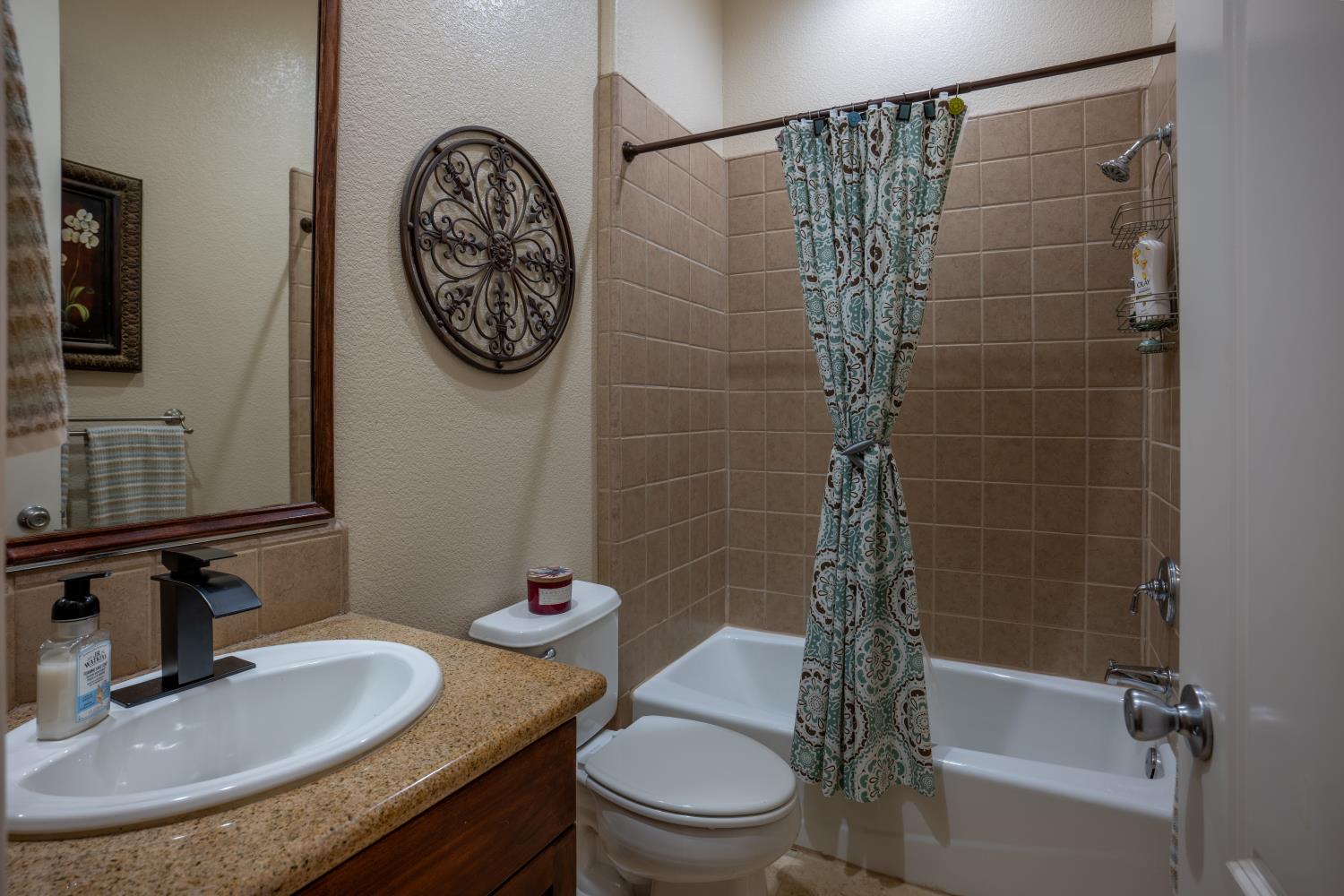 3388 Sudbury Road Cameron Park, CA 95682 - Photo 21 of 47 a bathroom with a sink a toilet and shower