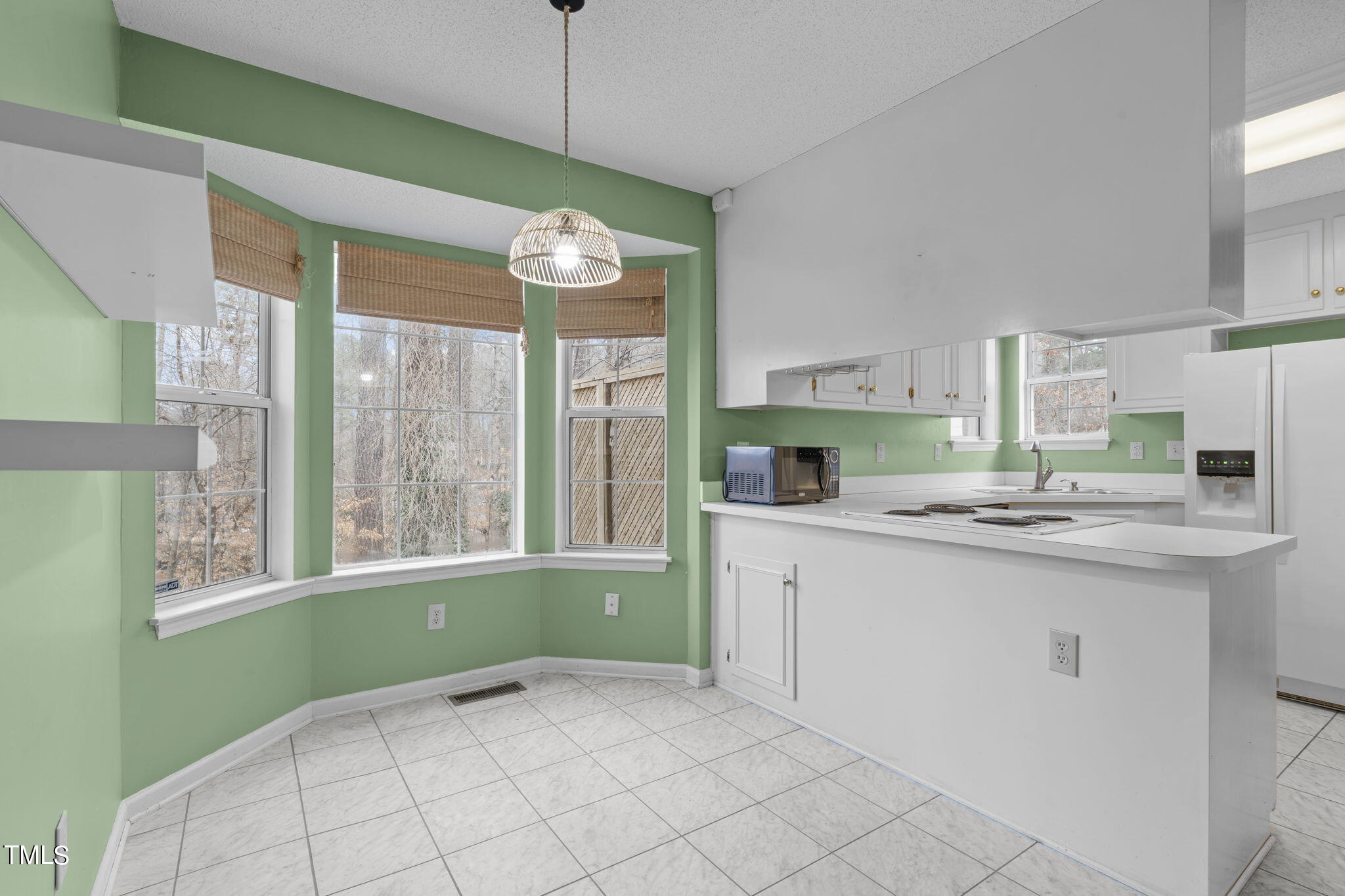 4624 Timberhurst Drive Raleigh, NC 27612 - Photo 12 of 29 a open kitchen with granite countertop a sink and a stove top oven