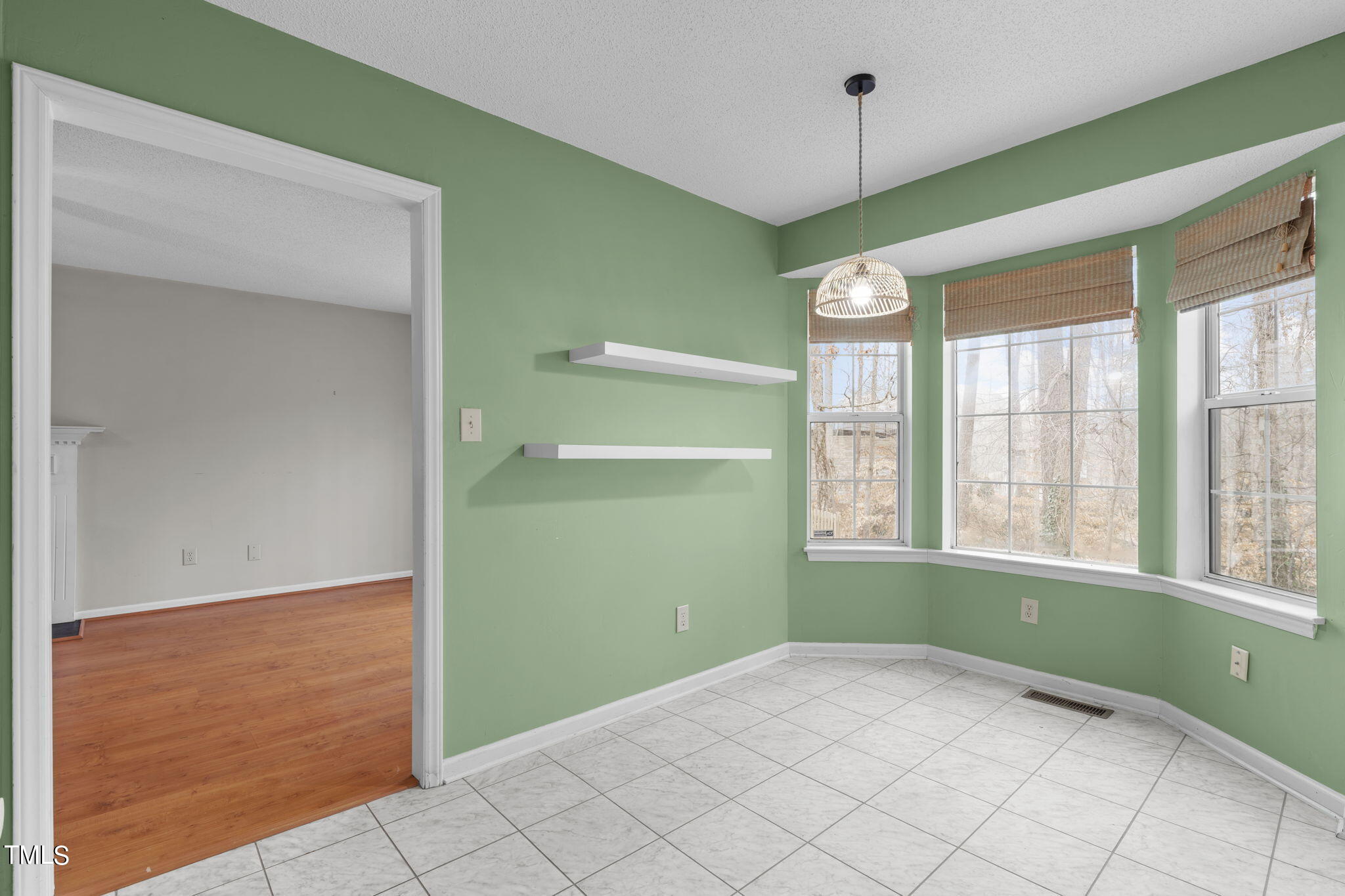 4624 Timberhurst Drive Raleigh, NC 27612 - Photo 13 of 29 a view of an empty room with window and cabinet