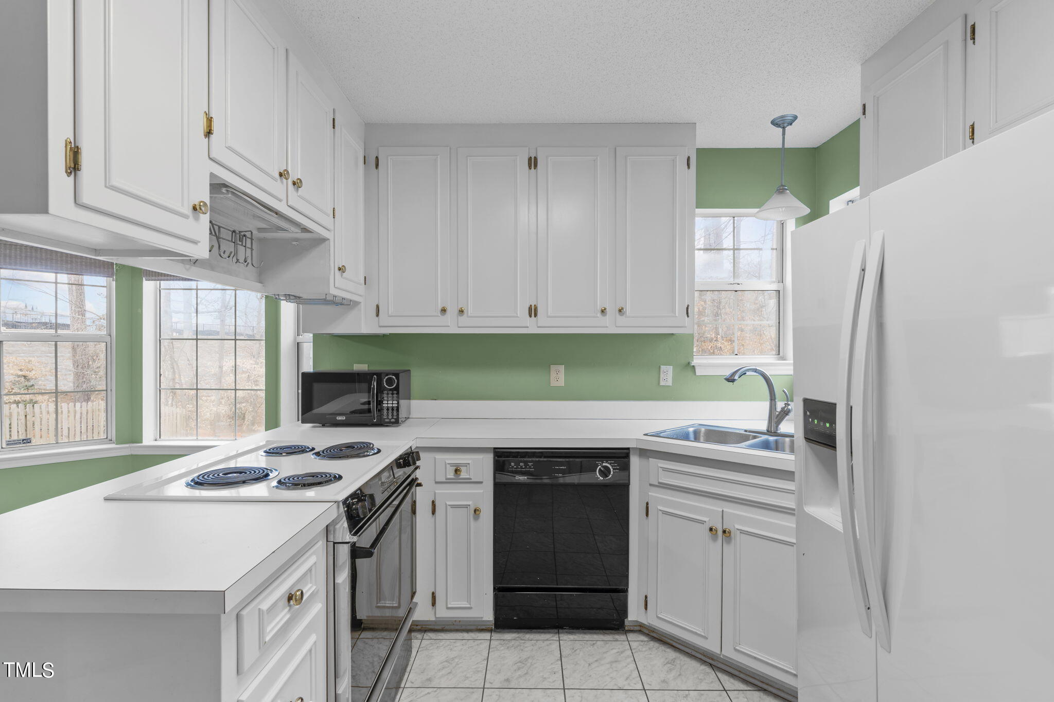 4624 Timberhurst Drive Raleigh, NC 27612 - Photo 15 of 29 a kitchen with stainless steel appliances a stove a sink and a refrigerator