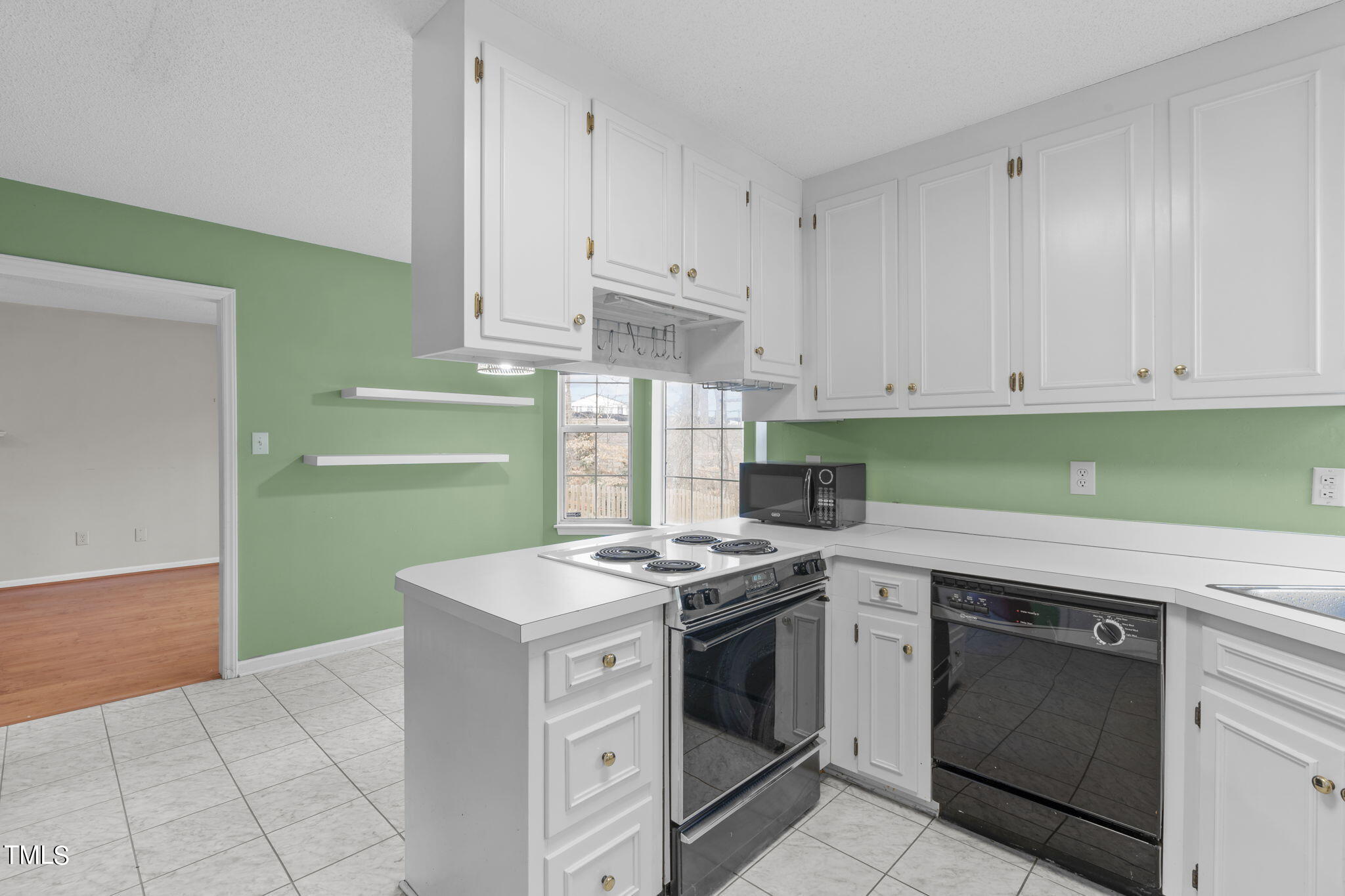 4624 Timberhurst Drive Raleigh, NC 27612 - Photo 16 of 29 a kitchen with granite countertop a stove and a sink