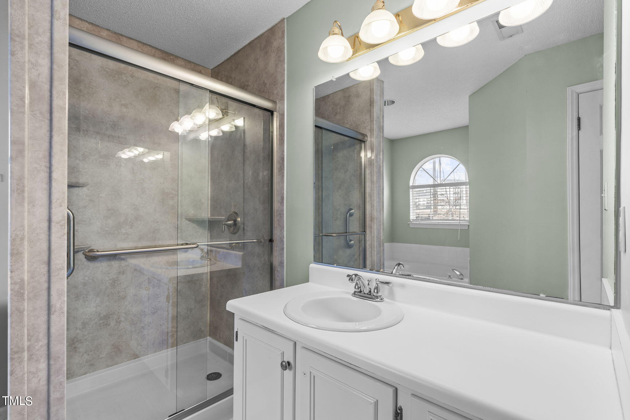 4624 Timberhurst Drive Raleigh, NC 27612 - Photo 22 of 29 a bathroom with a sink vanity granite shower and a mirror