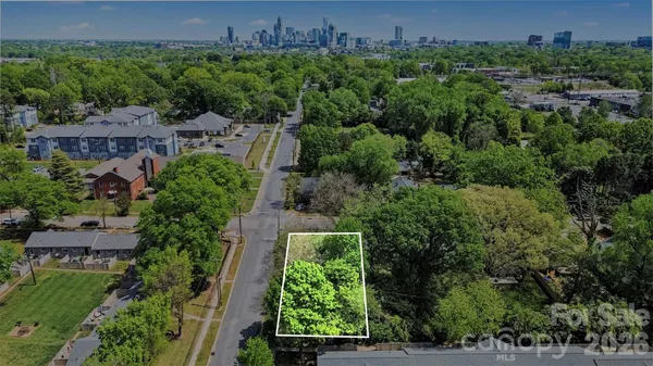 an aerial view of a house with yard