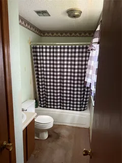 a bathroom with a black and white checkered floor