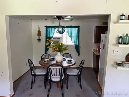 a dining room with furniture and window