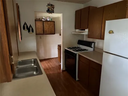 a kitchen with a refrigerator and a stove