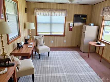 a living room with furniture a window and a flat screen tv