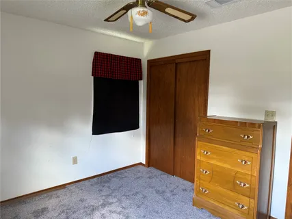 a view of a hallway to a closet and a couch