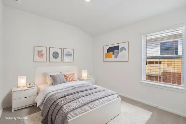 a bedroom with a large bed and a window