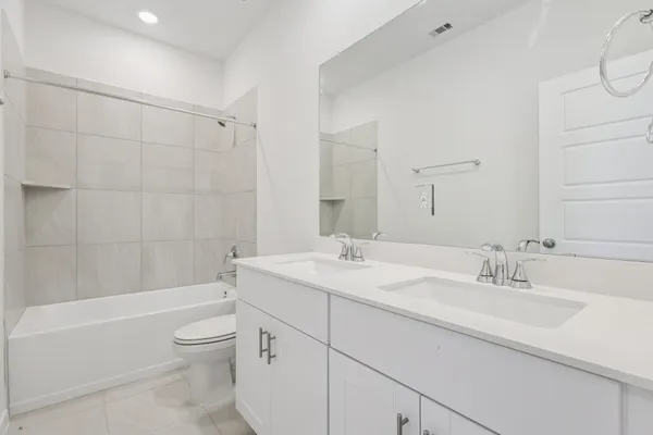 a bathroom with a sink a toilet and bathtub