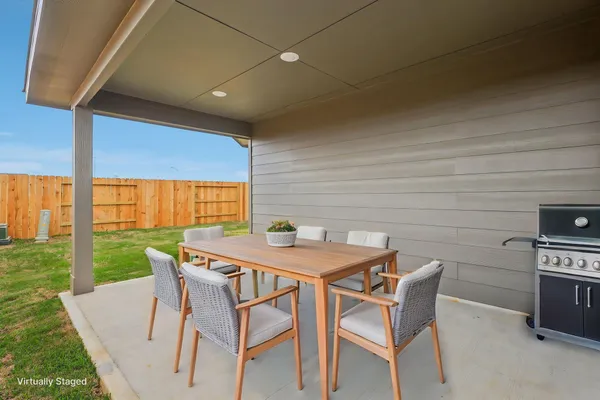 a view of a patio with table and chairs